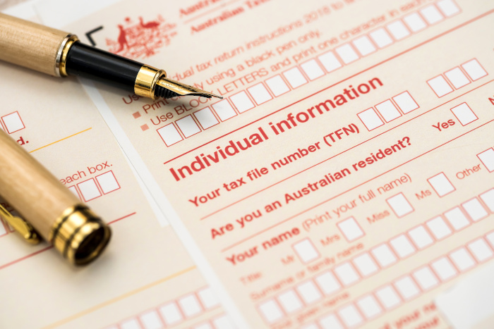 Australian annual tax form with pen.